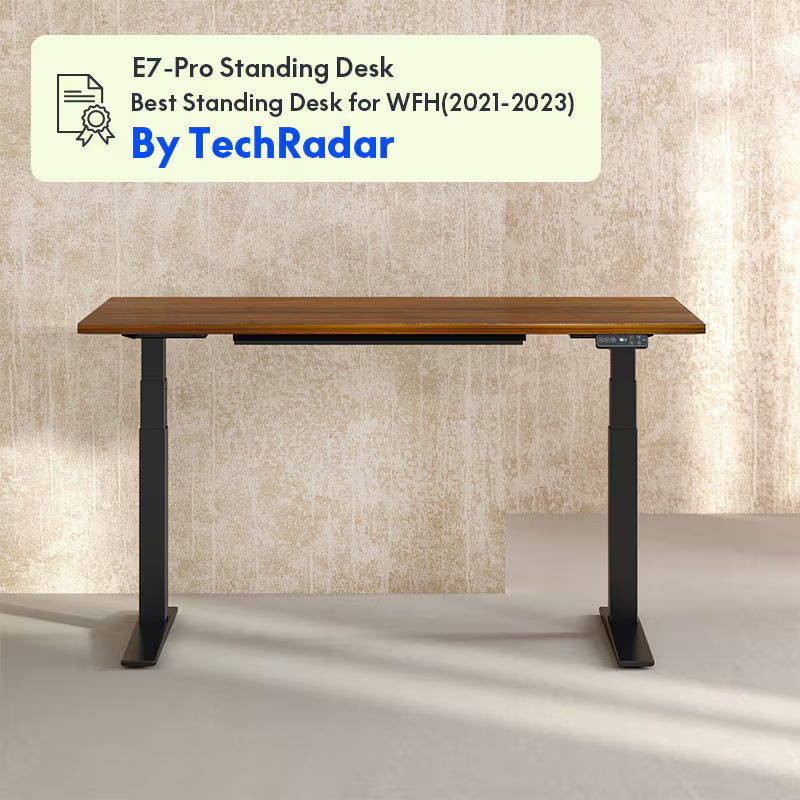 E7-Pro standing desk with a beige wall background