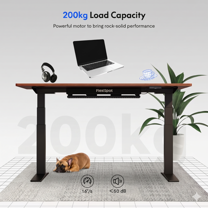 FlexiSpot desk with laptop, headphones, and a dog on a white background